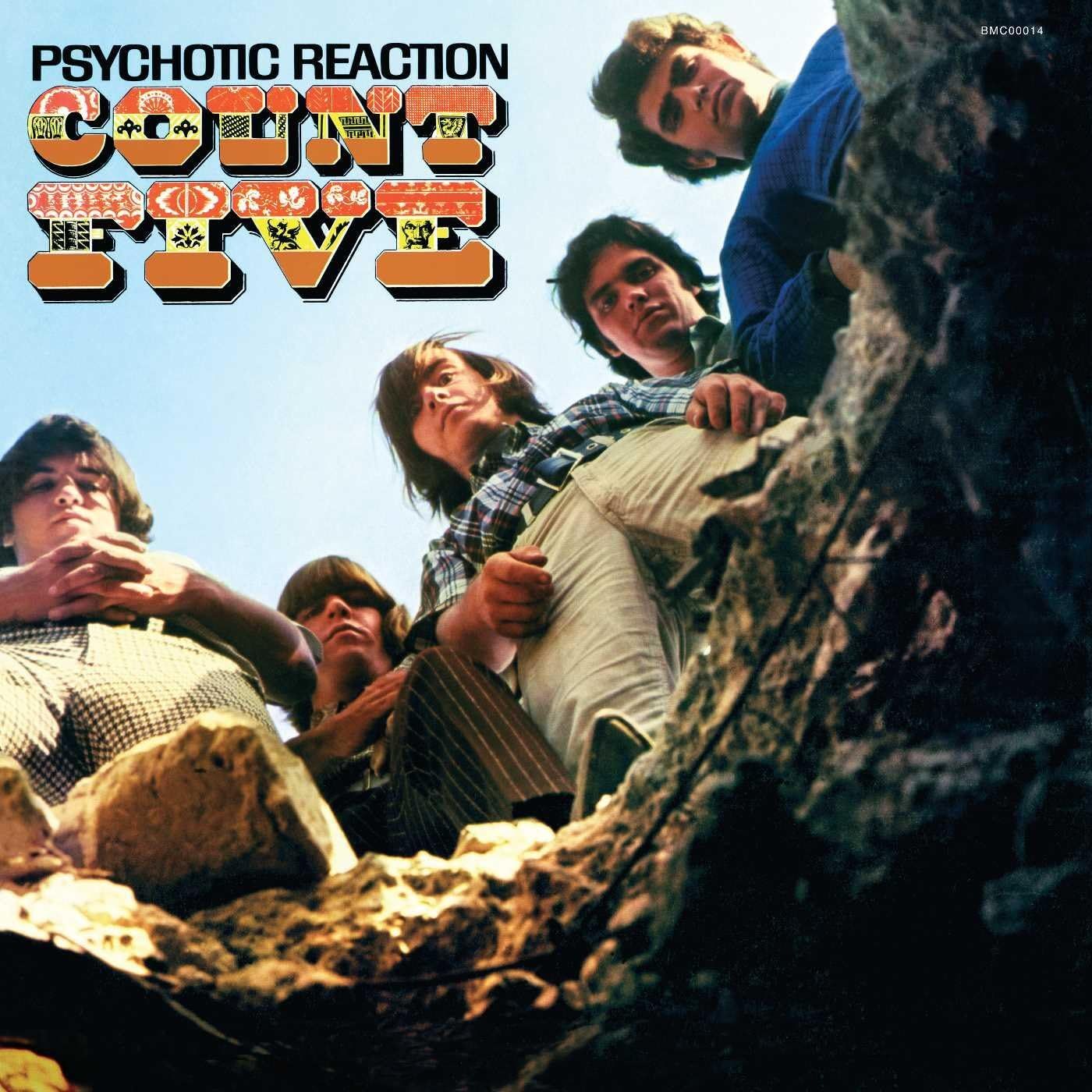Count Five Psychotic Reaction album cover featuring a low-angle photo of the band looking down into a rocky pit against a blue sky, with bold psychedelic Count Five lettering and album title at the top, classic garage rock artwork available from Utopia Records.